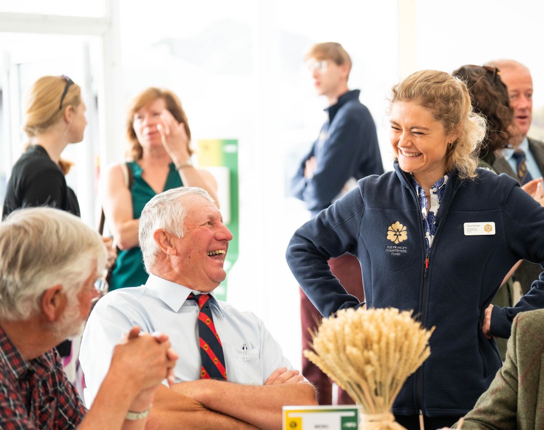 Female member of staff from Prince's Countryside Fund interacting with members of the public