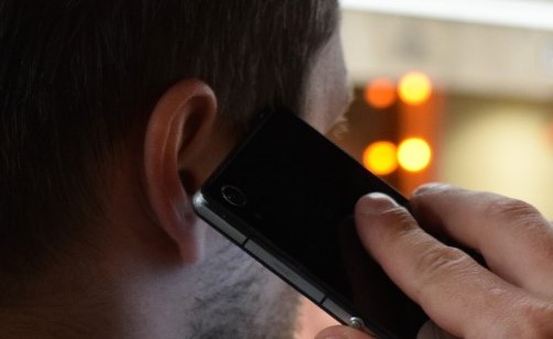 Crop of man talking on a mobile phone