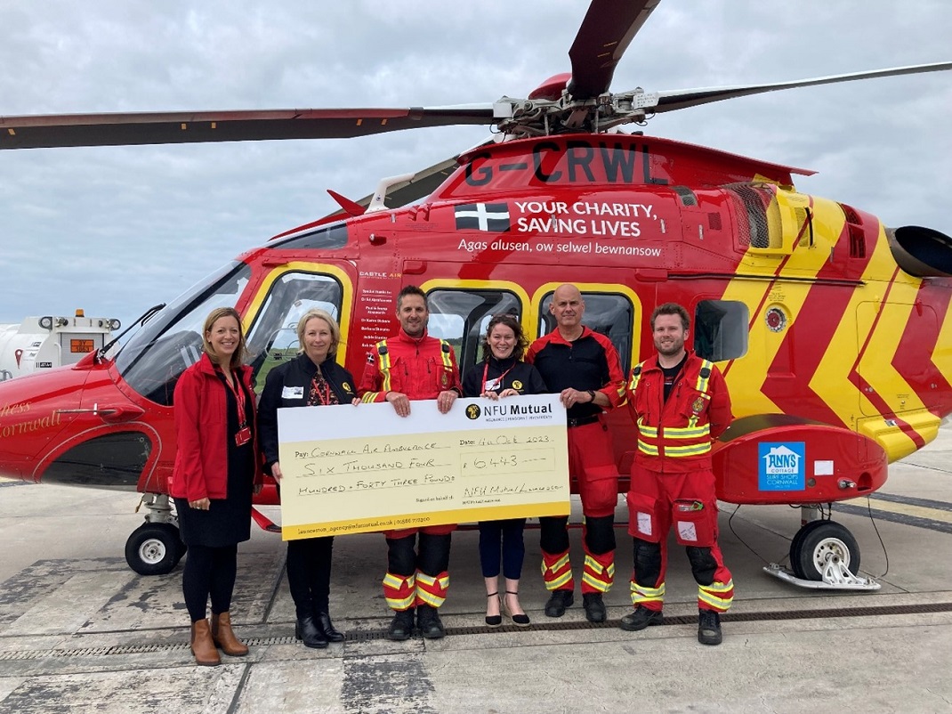 Tiverton Agency presenting cheque to Cornwall air ambulance